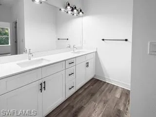 a bathroom with a double vanity sink and mirror