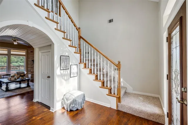 a view of entryway and hall with wooden floor