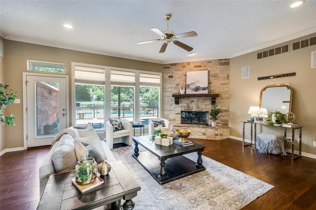 a living room with furniture fireplace and a large window