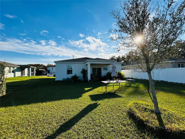 a view of a house with swimming pool and sitting area