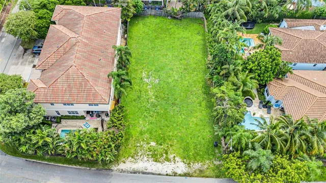 an aerial view of a house with a yard and garden