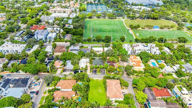 an aerial view of residential houses with outdoor space and street view