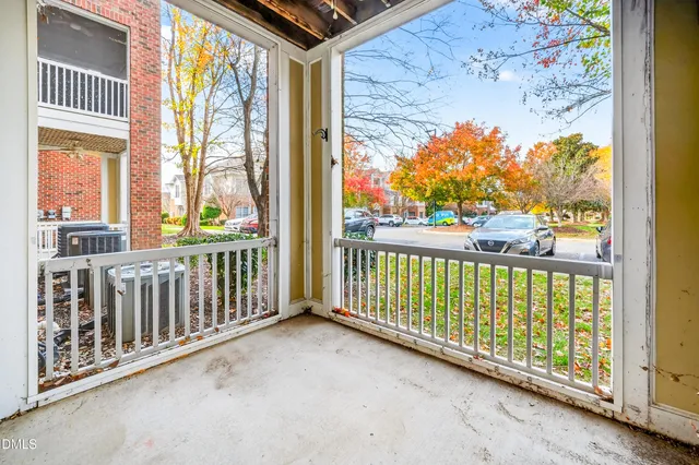 a view of a street with cars parked on the street side