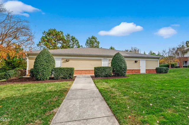 a view of a hallway with wooden fence