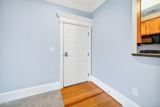 a view of a room with wooden floor and a window