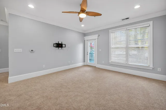 a view of a livingroom with a ceiling fan and window