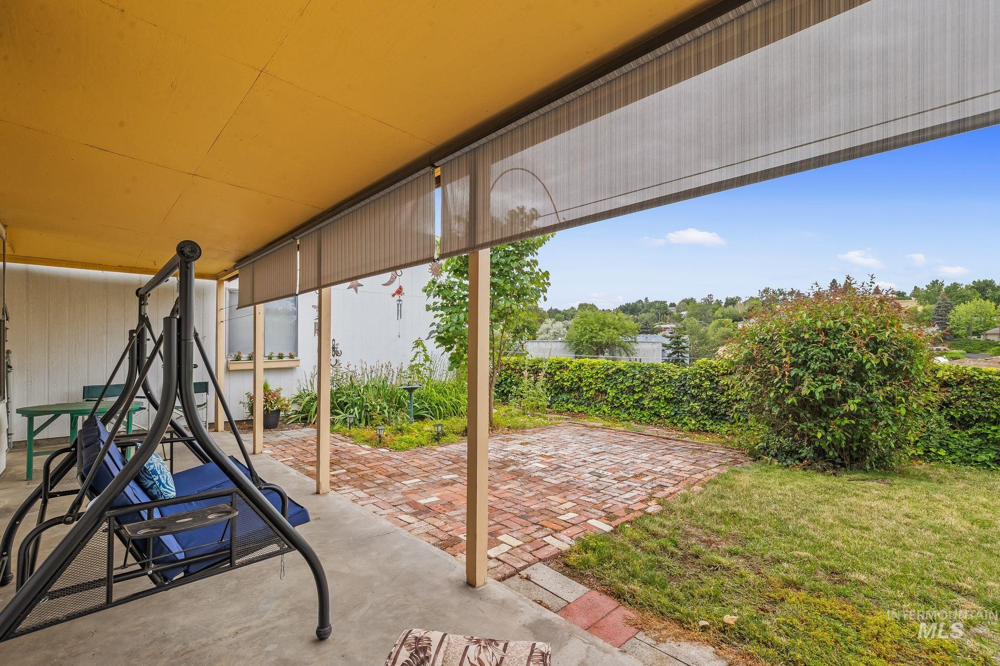 1721 3rd Street Lewiston, ID 83501 - Photo 20 of 45 Covered concrete patio featuring an exposed aggregate finish and a bright yellow ceiling