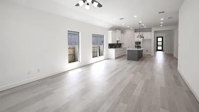 a view of a backyard with brick wall and wooden fence