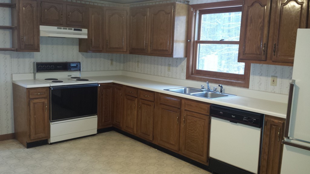 22 Scott Road Townsend, MA 01474 - Photo 11 of 24 a kitchen with a sink stove top oven and cabinets