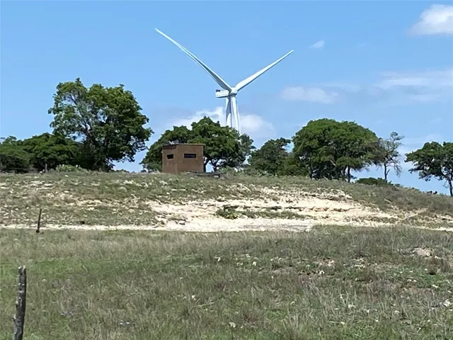 a view of a dirt road with a building in the background
