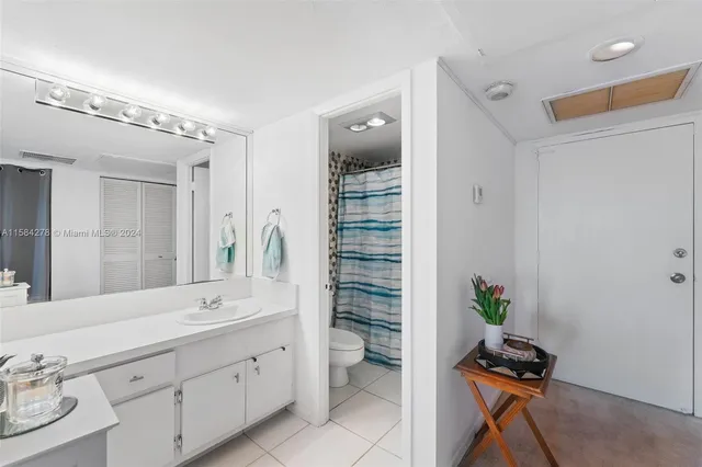 a spacious bathroom with a shower sink and mirror
