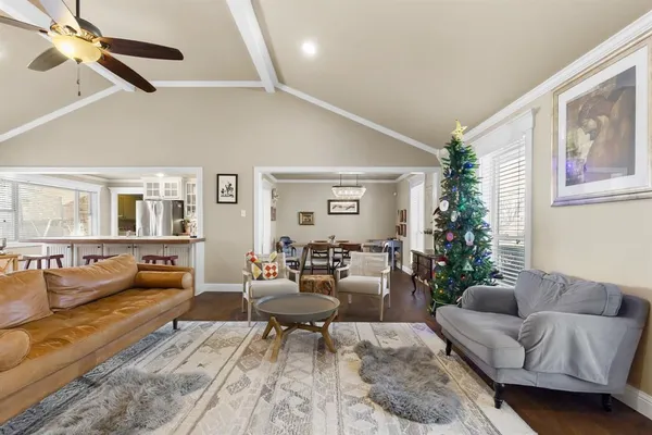 a living room with furniture and flowers
