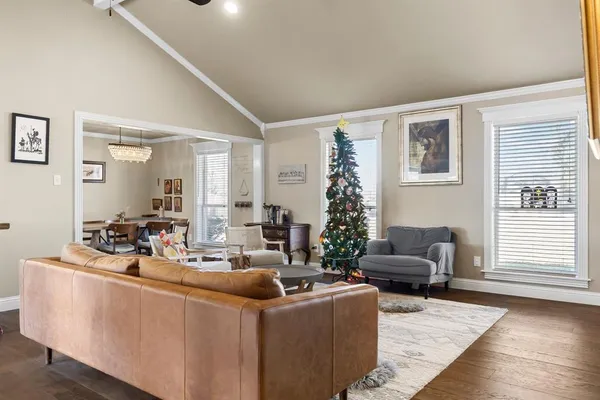 a living room with furniture a piano and a window