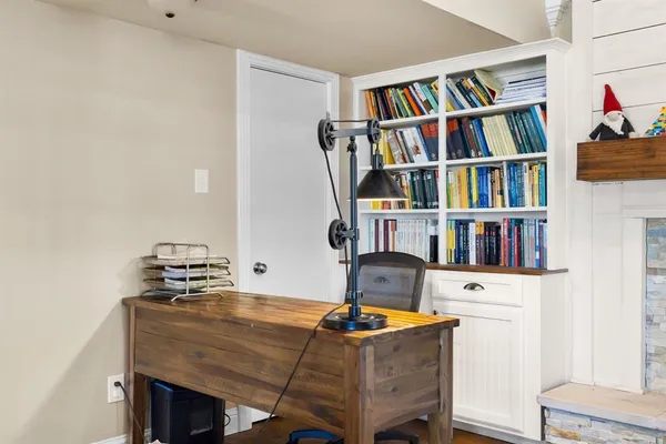 a living room with a bookshelf and a fireplace