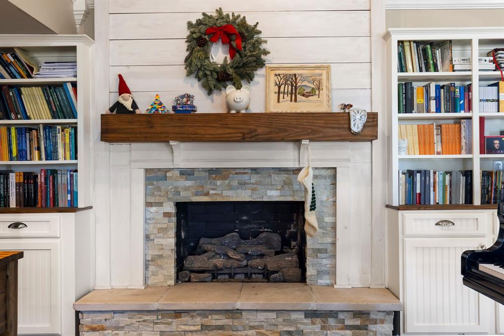 601 Rasure Circle Sulphur Springs, TX 75482 - Photo 18 of 40 a living room with a bookshelf and a fireplace
