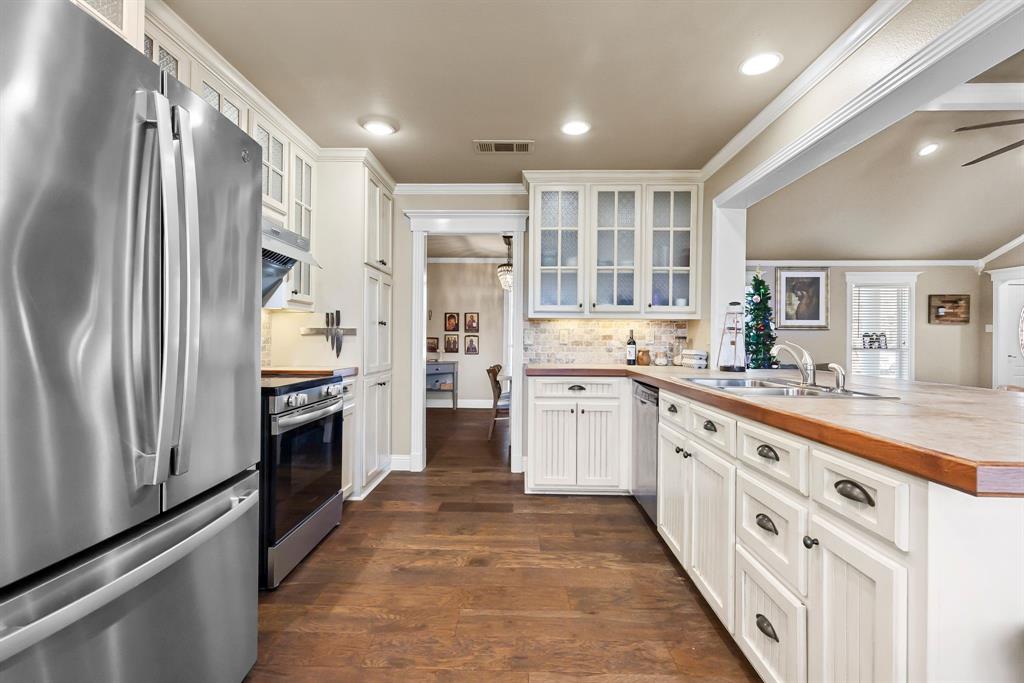 601 Rasure Circle Sulphur Springs, TX 75482 - Photo 23 of 40 a large kitchen with stainless steel appliances a refrigerator sink and cabinets