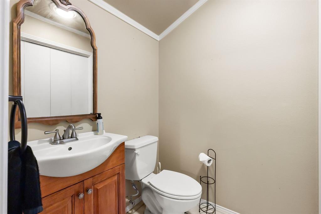 601 Rasure Circle Sulphur Springs, TX 75482 - Photo 25 of 40 a bathroom with a sink vanity mirror and toilet