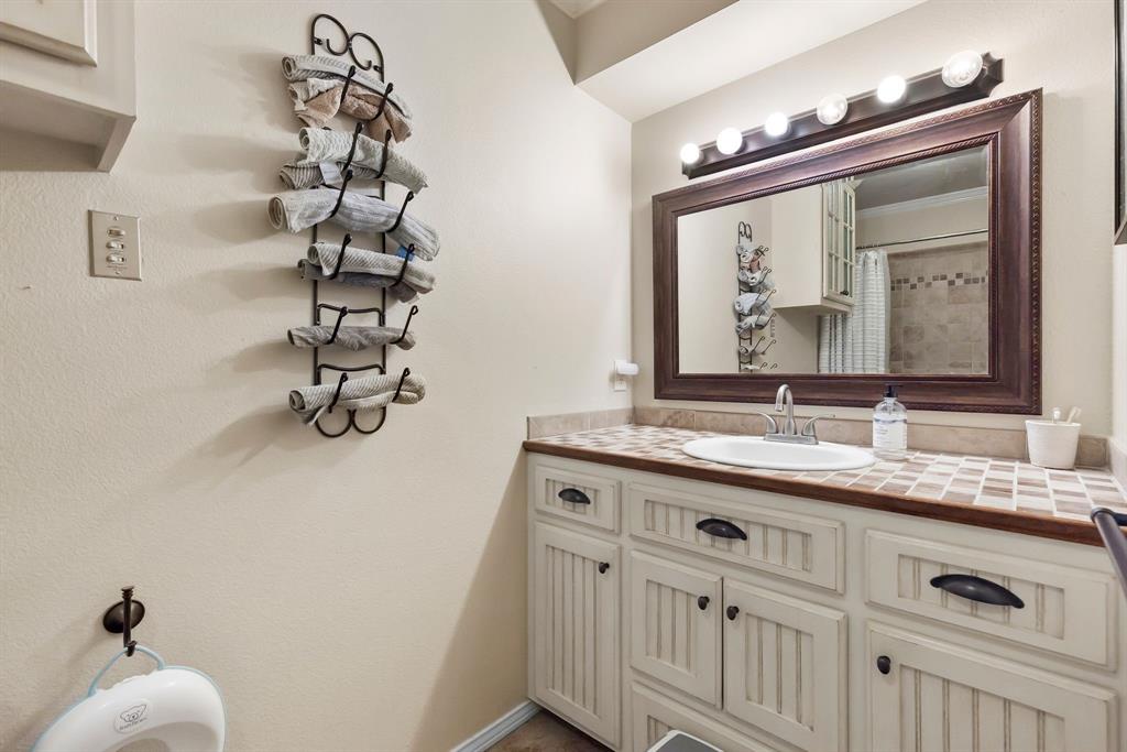 601 Rasure Circle Sulphur Springs, TX 75482 - Photo 26 of 40 a bathroom with a sink vanity and a mirror