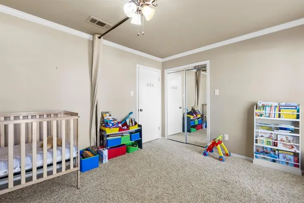 a bedroom with furniture and a large window