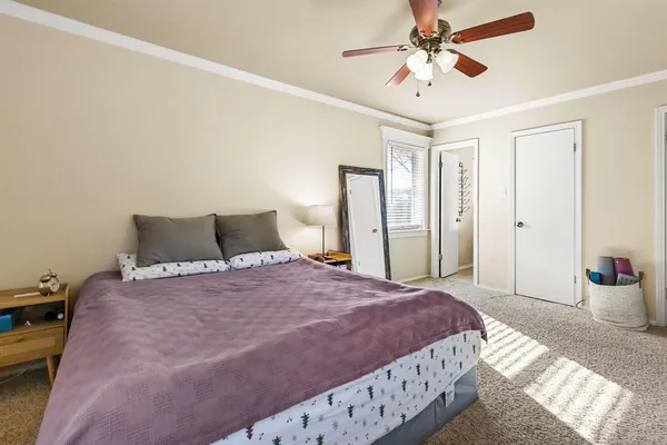 a spacious bedroom with a bed and a chandelier