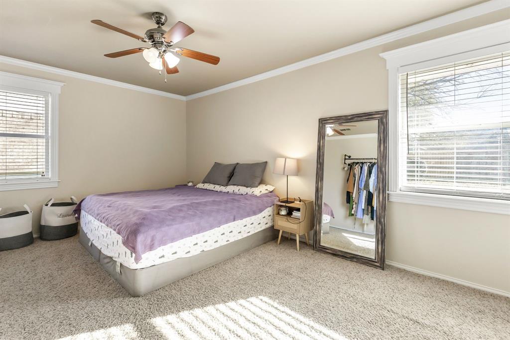 601 Rasure Circle Sulphur Springs, TX 75482 - Photo 33 of 40 a spacious bedroom with a bed and a chandelier