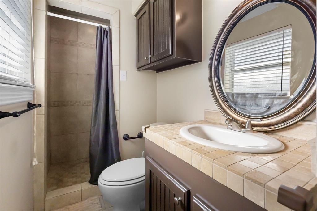 601 Rasure Circle Sulphur Springs, TX 75482 - Photo 35 of 40 a bathroom with a sink a toilet and a mirror