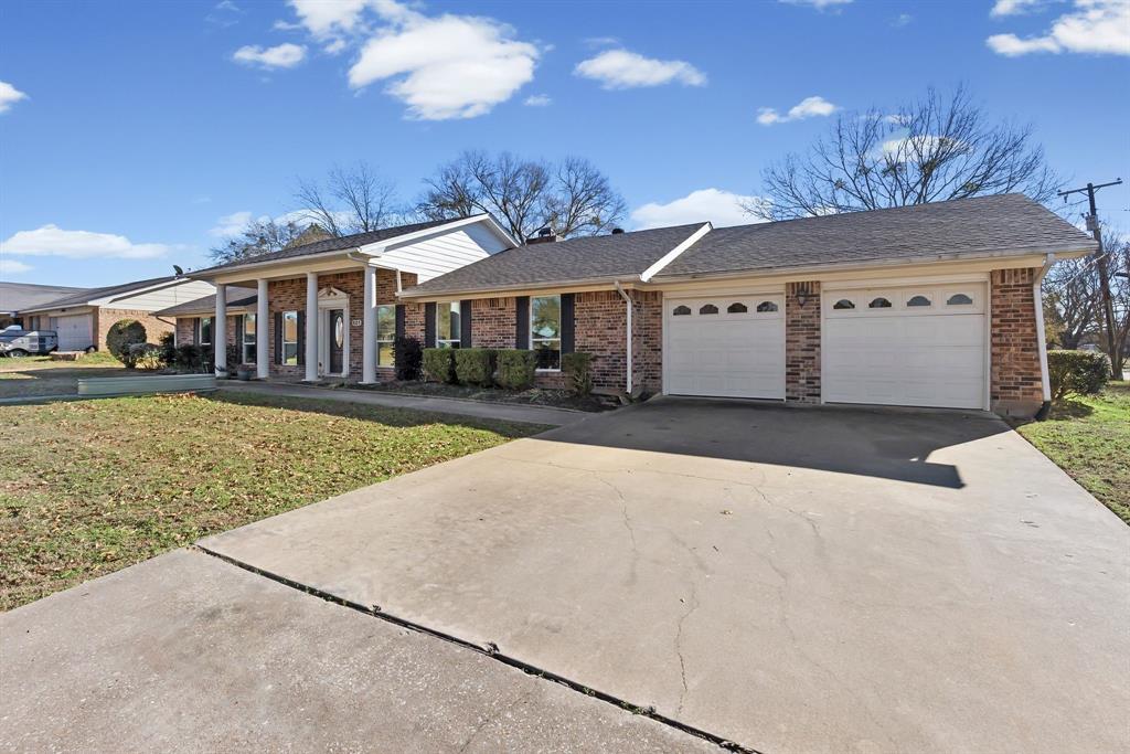 601 Rasure Circle Sulphur Springs, TX 75482 - Photo 7 of 40 a front view of a house with a yard and potted plants