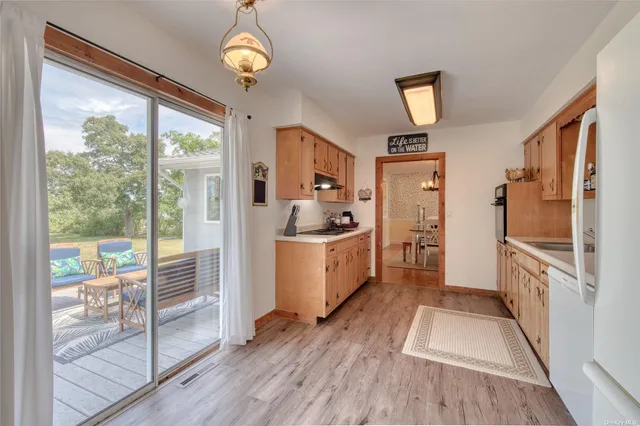 a kitchen with a refrigerator a stove top oven and a large window