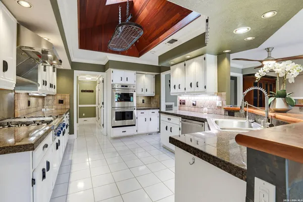 a kitchen with stainless steel appliances granite countertop a sink and cabinets
