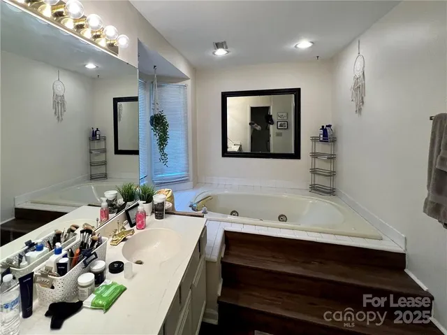 a bathroom with a sink mirror and vanity