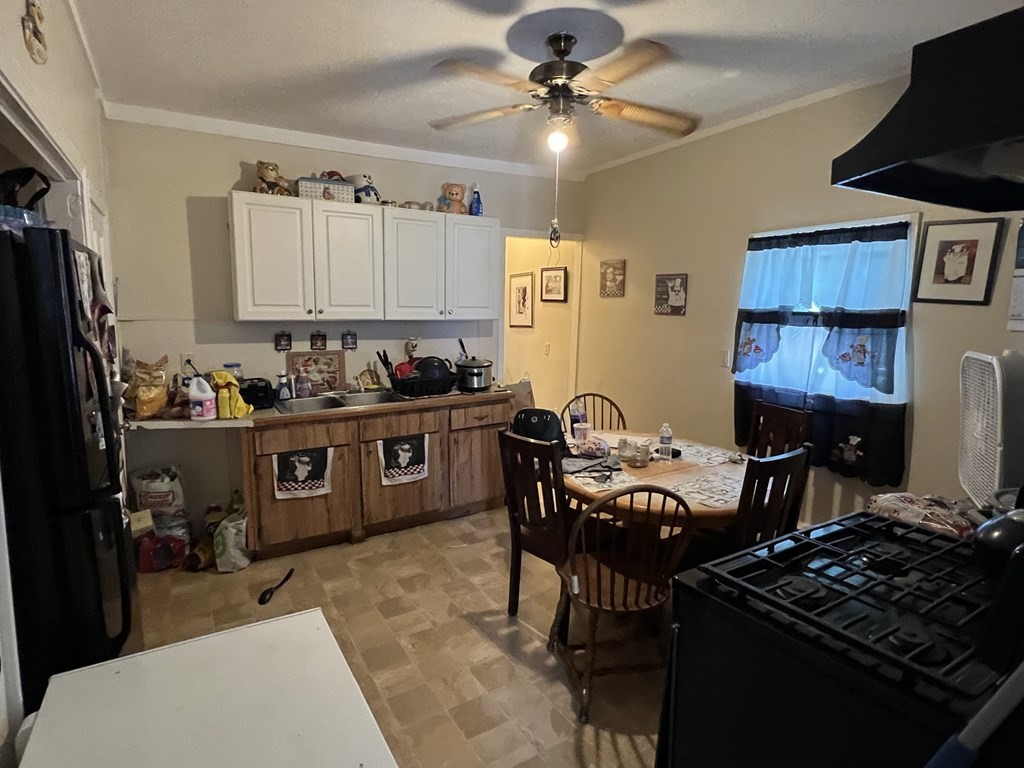 2-4 Prospect Street Haverhill, MA 01832 - Photo 19 of 42 a kitchen with a stove a refrigerator and a dining table