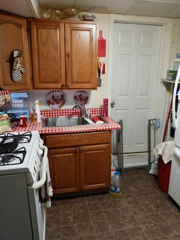 2-4 Prospect Street Haverhill, MA 01832 - Photo 24 of 42 a utility room with stainless steel appliances wooden cabinets and a stove top oven