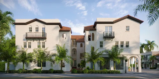 a view of white house with a yard and plants