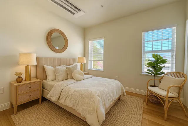 a bedroom with a bed flowerpot and a window