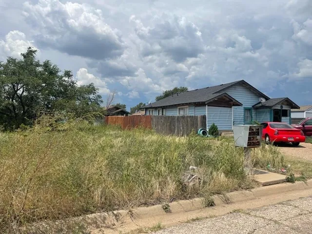 a view of a house next to a yard