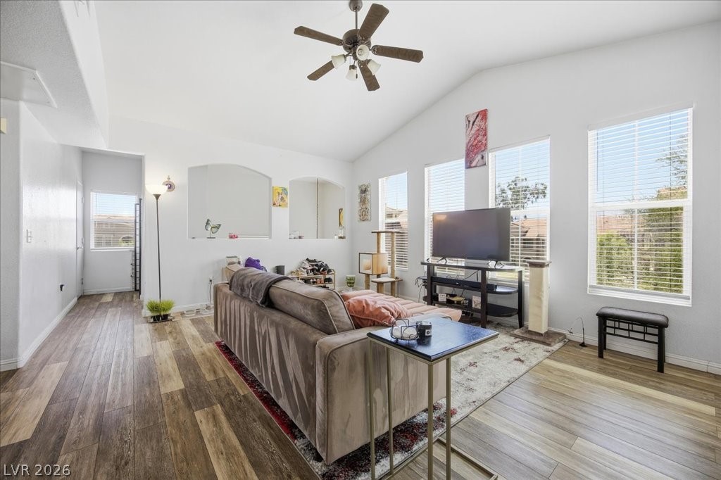 10550 West Alexander Road, Unit 2164 Las Vegas, NV 89129 - Photo 7 of 27 An inviting great room with wood flooring and vaulted ceilings creates a bright, open living space.