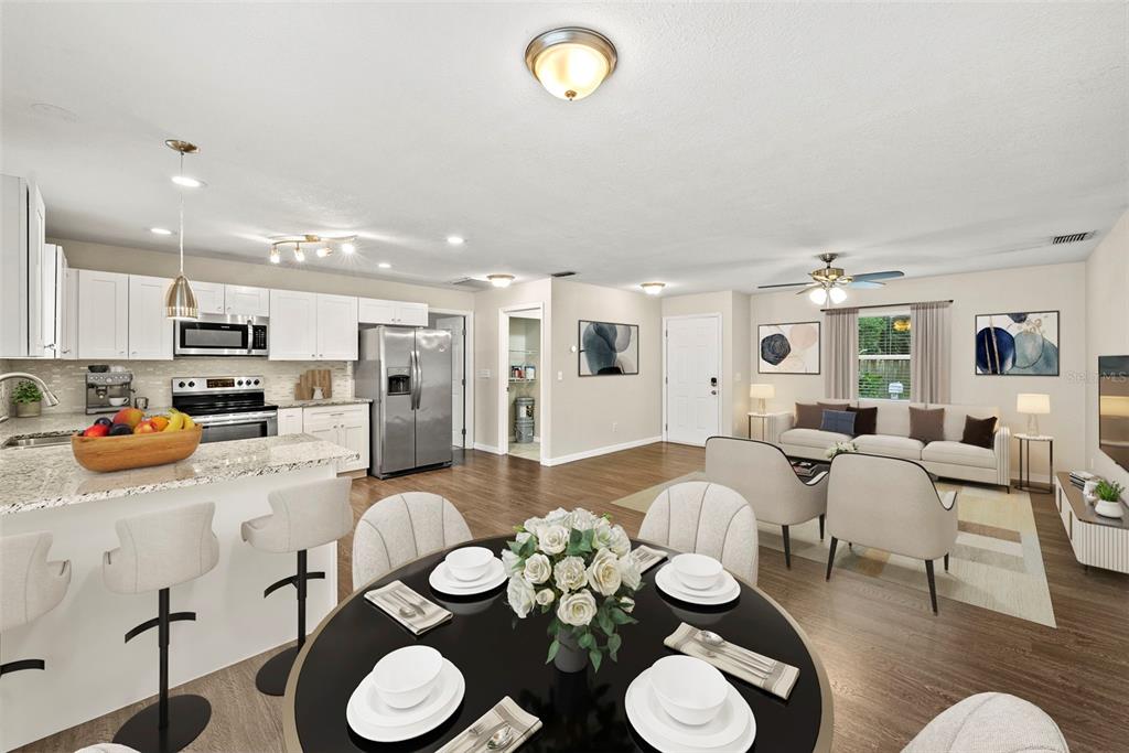 6601 North Elizabeth Street Tampa, FL 33604 - Photo 4 of 35 a large kitchen with stainless steel appliances couches chairs and a dining table with wooden floor