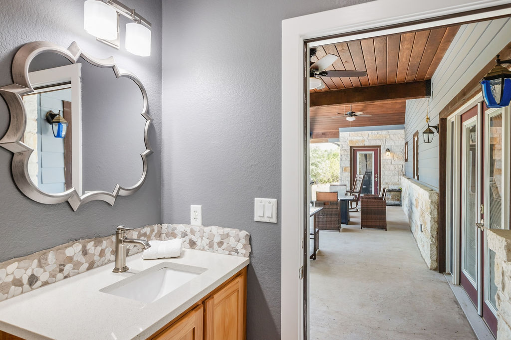 13326 Trautwein Road Austin, TX 78737 - Photo 26 of 38 Bathroom with ceiling fan, wood ceiling with exposed beams, a textured wall, vanity, and wooden walls