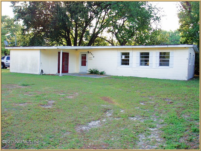 6876 Camelot Road Jacksonville, FL 32211 - Photo 1 of 11 a view of a yard in front of a house with large trees