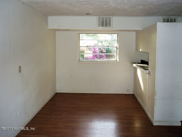 6876 Camelot Road Jacksonville, FL 32211 - Photo 3 of 11 an empty room with wooden floor and windows