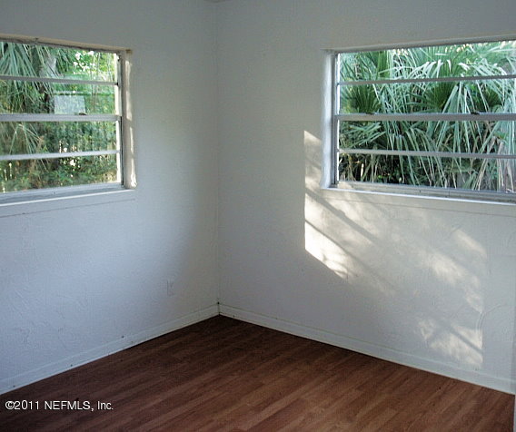 6876 Camelot Road Jacksonville, FL 32211 - Photo 8 of 11 a view of an empty room with wooden floor and a window