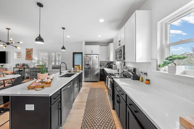 a kitchen with a sink stove and cabinets