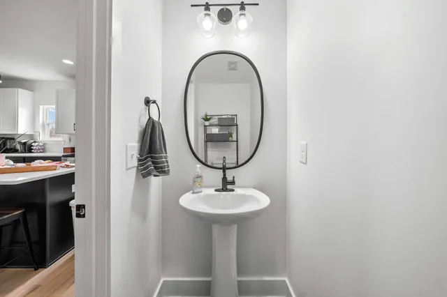 a bathroom with a sink a mirror and a shower