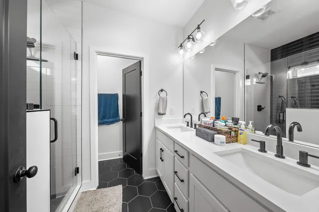 a bathroom with a double vanity sink mirror and double