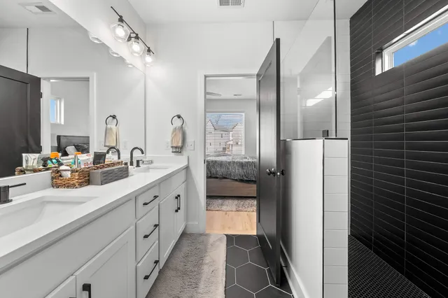 a spacious bathroom with a double vanity sink and a mirror