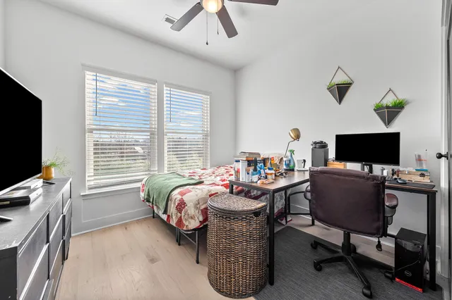 a bedroom with a bed and a flat screen tv