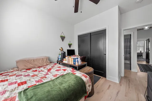 a bedroom with a bed and wooden floor