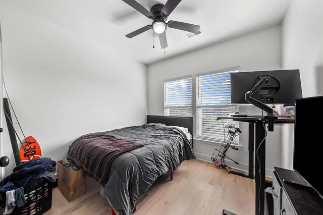 a bedroom with a bed and a chandelier