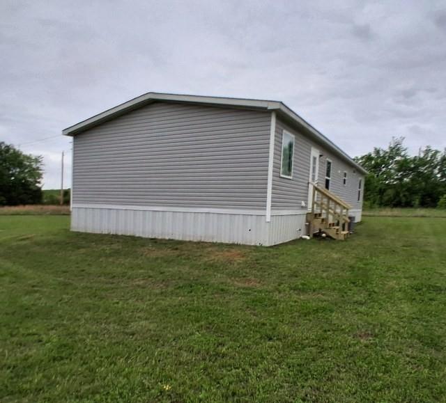 798 North 4190 Road Hugo, OK 74743 - Photo 15 of 16 a house with a yard