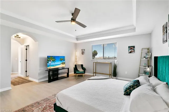 a bedroom with a bed and painting on the wall